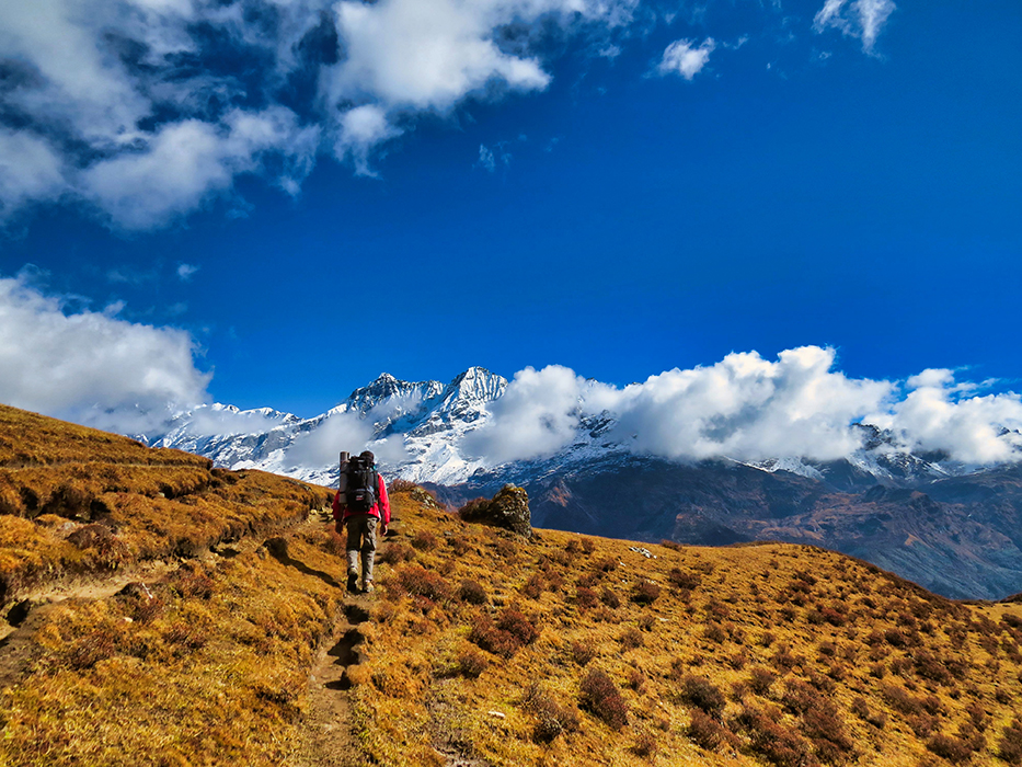 Tourist walks towards beautiful mountains in Sikkim