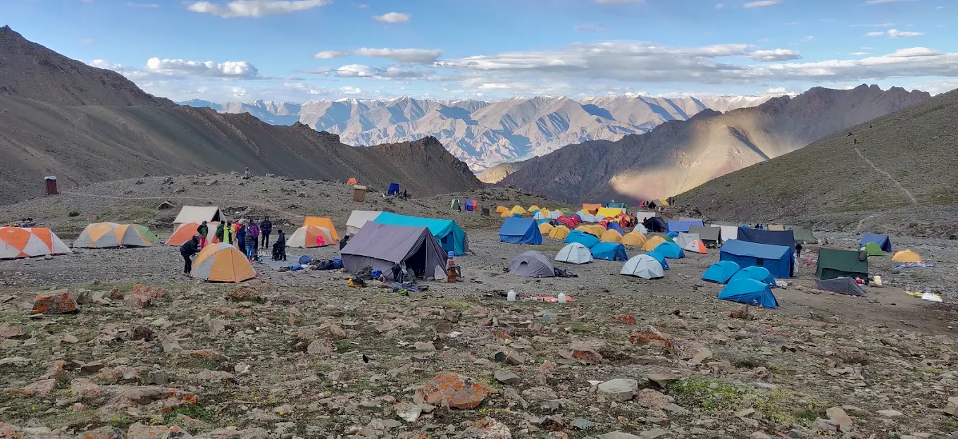 Black Yak Expedition: Vibrant high-altitude trekking campsite packed with colorful tents and trekkers in the majestic Sikkim Himalayas &ndash; Premier travel agent in Sikkim for epic trekking adventures in Sikkim & Ladakh