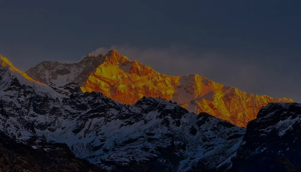 Golden sunrise over Kanchenjunga from Dzongri Top on the Goechala Trek route in Sikkim Himalayas.